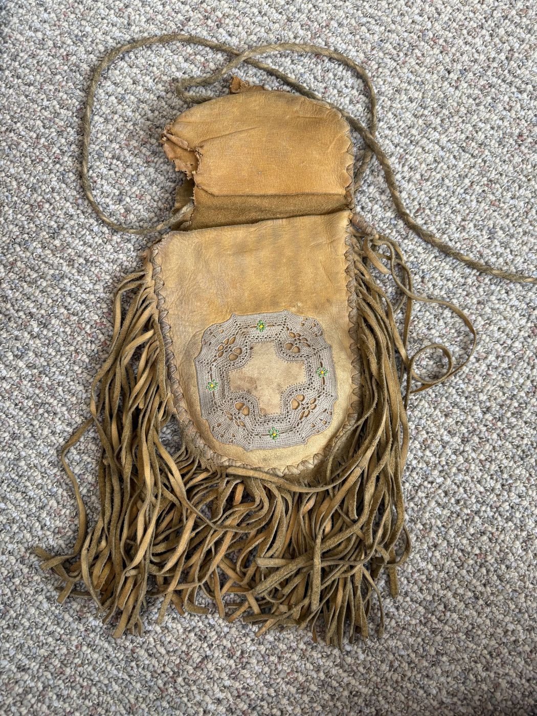 A beaded leather pouch she made